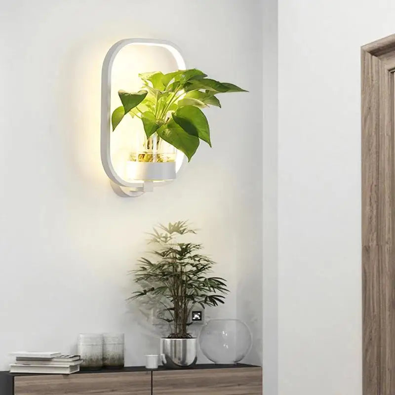 Elegant LuminaireSconce plantevæglampe i glas med naturligt design, perfekt til stilfulde interiører, oplyst med koldt eller varmt hvidt lys.
